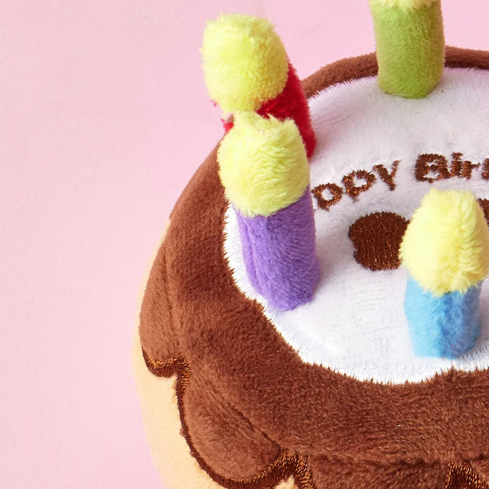 Brown pet plush toy shaped like a birthday cake with a candle, 40g, for dogs to chew and play