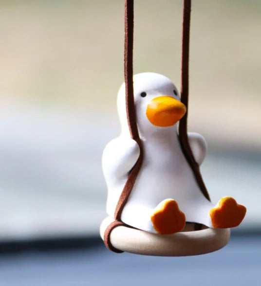 Gypsum duck ornament with swing tire design measuring 6x5x6cm for decorative displays