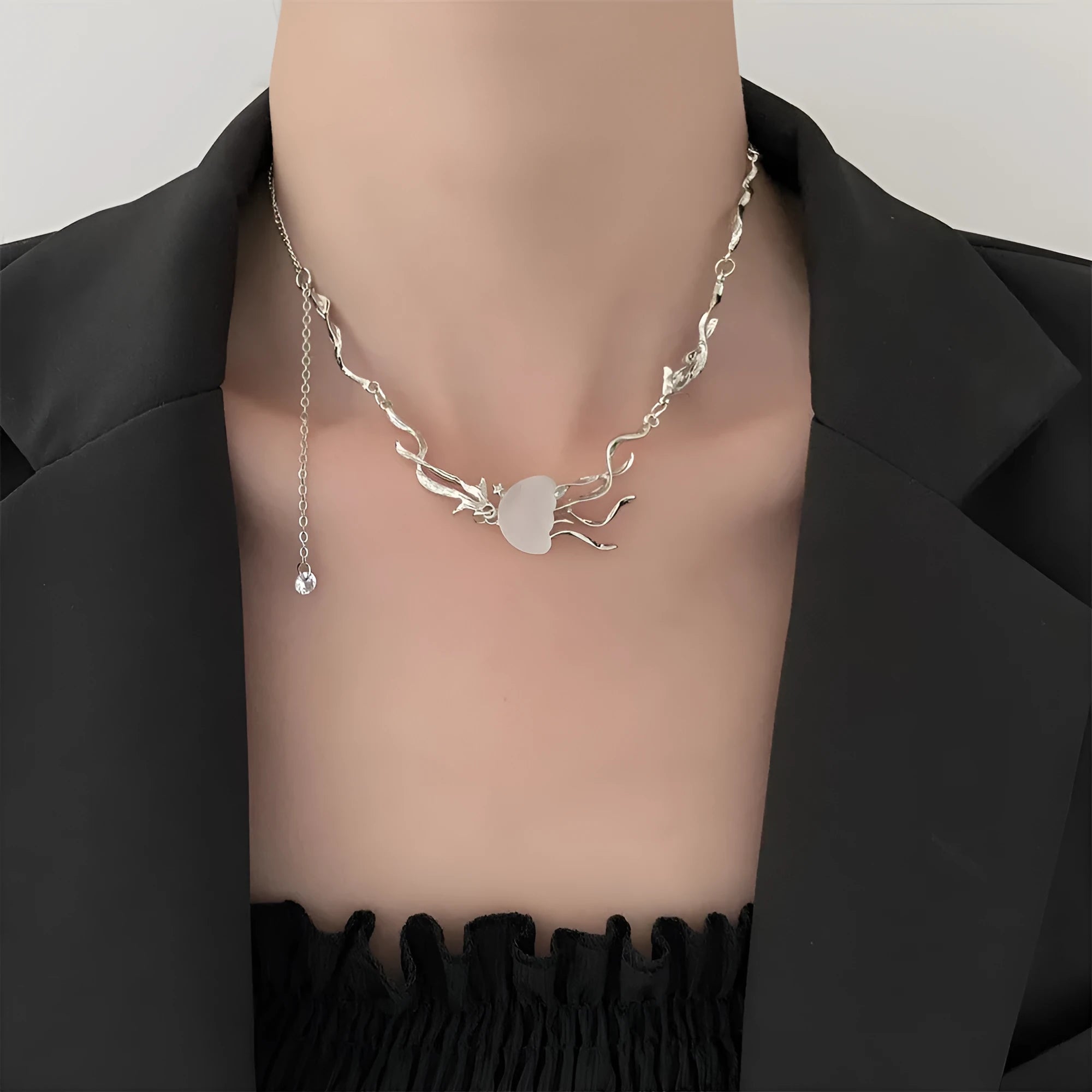 Alloy jellyfish tassel necklace and earring set in electroplated white finish on display