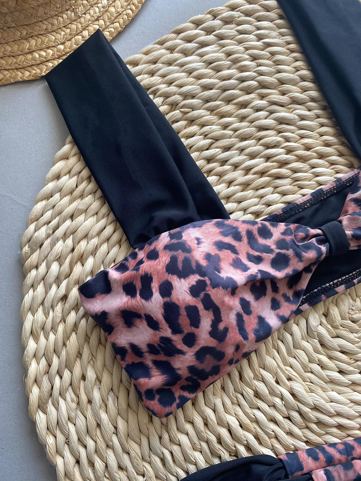 Black women's bikini with leopard print tube top and matching split T-back pant.