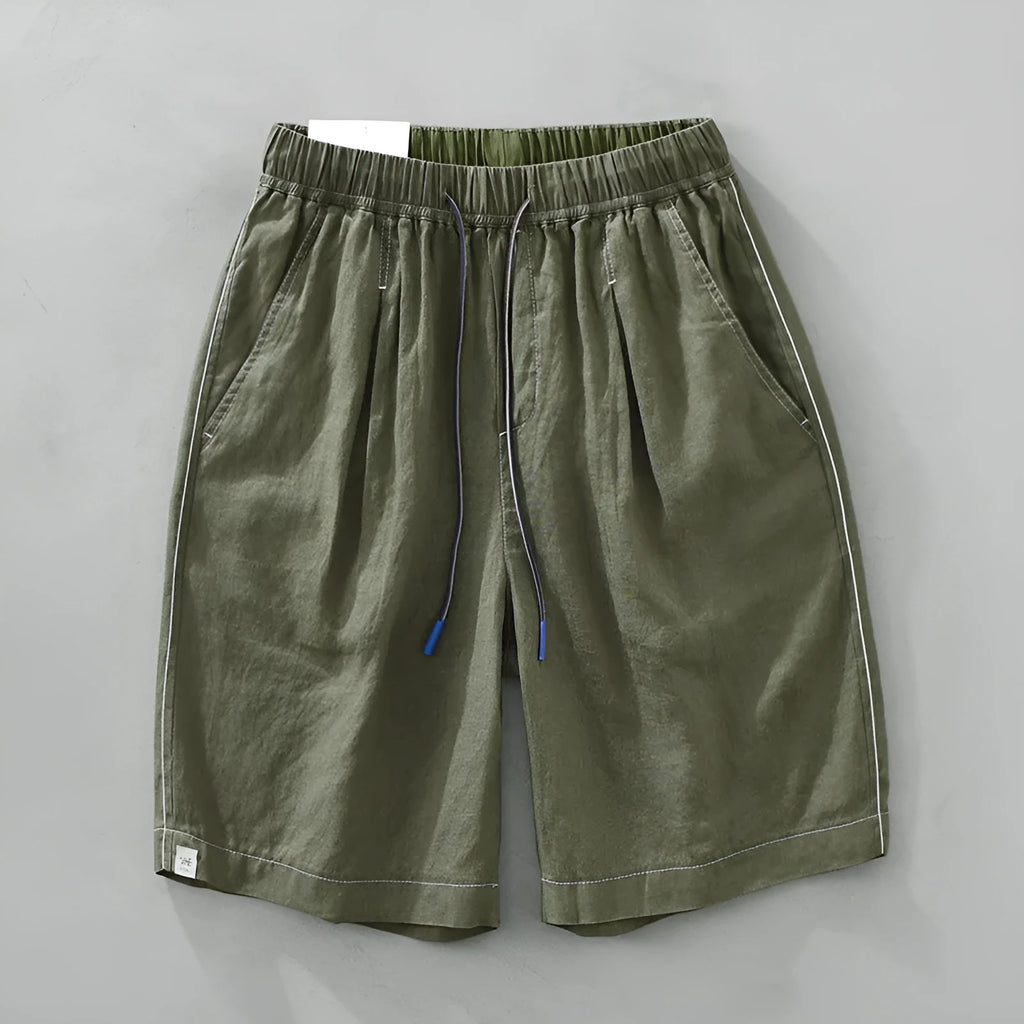 Men's loose straight fit linen shorts in green with drawstring waist, shown laid flat