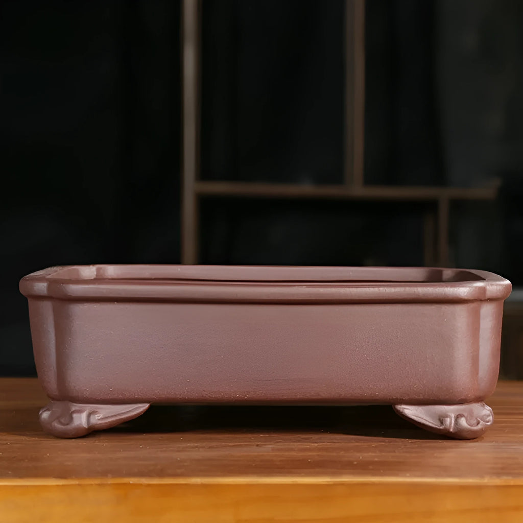 Antique-style rectangular purple sand bonsai pot on a floor.