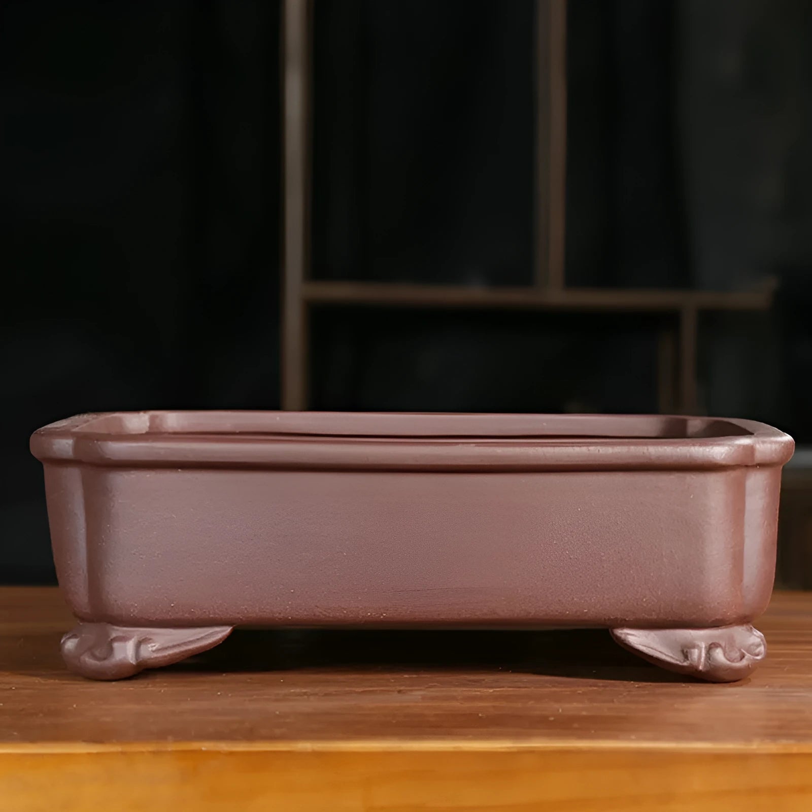 Antique-style rectangular purple sand bonsai pot on a floor.