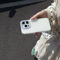 Clear jelly iPhone phone case in solid blue colour on an iPhone, showing bumper-style all-inclusive protection.