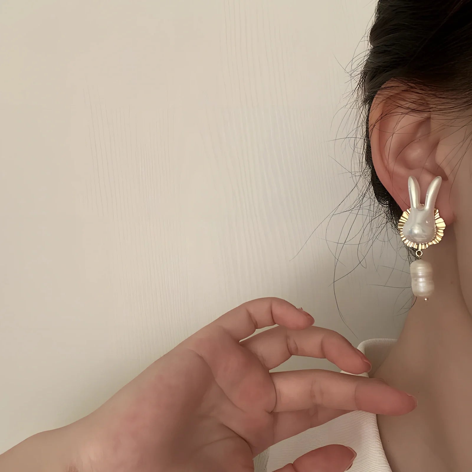 Silver bunny character earrings with baroque pearls measuring 2.5cm length with electroplated finish