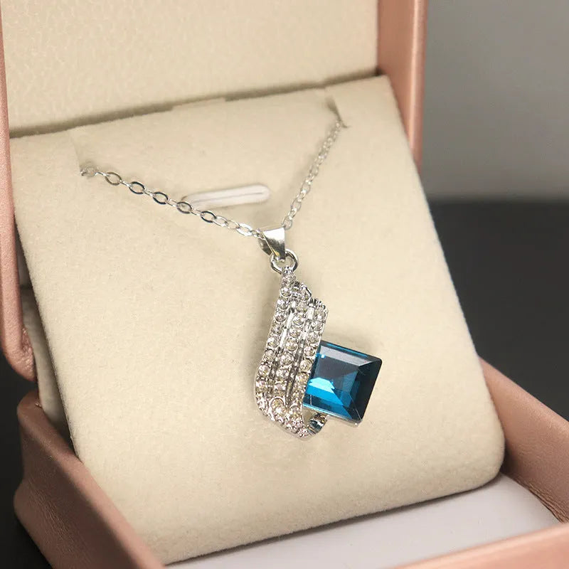 Women's alloy pendant necklace and matching stud earrings set with cross chain and glass accents