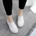 Low-top canvas trainers in black, white, grey and pink colours with plastic sole
