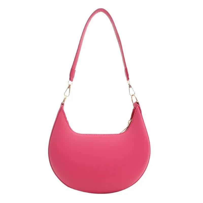 Round women's underarm bag in PU material showing sewing line detailing and internal phone compartment
