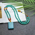 Turquoise mesh flower pendant on an adjustable ball bead necklace chain.