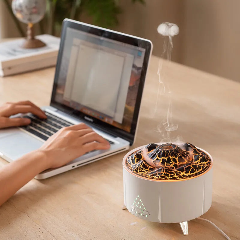 White portable simulated flame ultrasonic aromatherapy air humidifier with remote control on a table