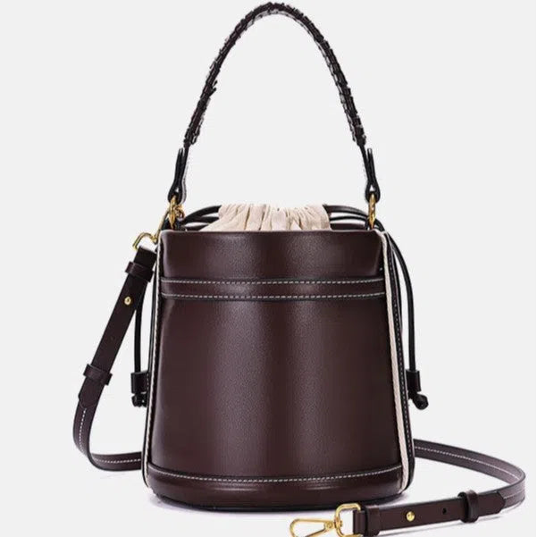 Brown PU cylindrical tote bag with dual handles and woven decorative stitching lines.