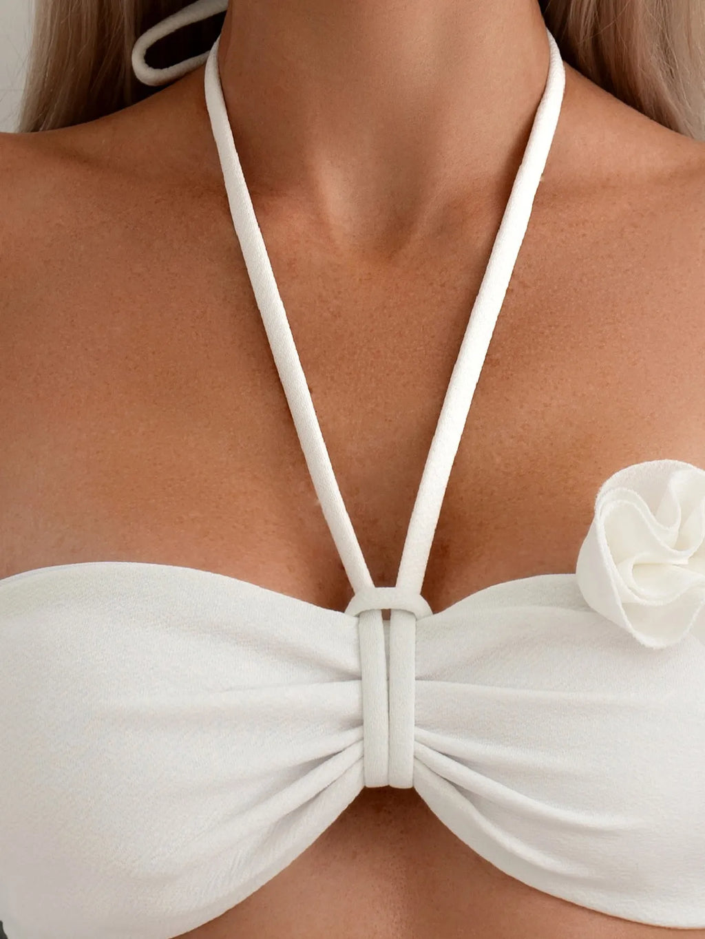 White halter neck bikini set with 3D flower design and lace-up back