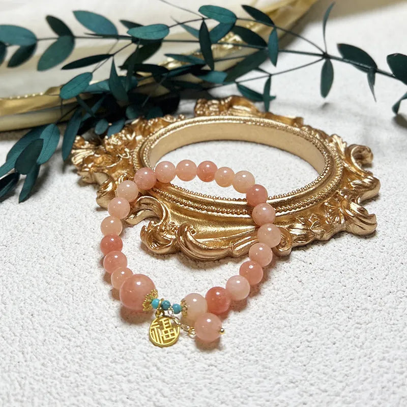 Women's pink natural stone bracelet with alloy metal setting and adjustable clasp
