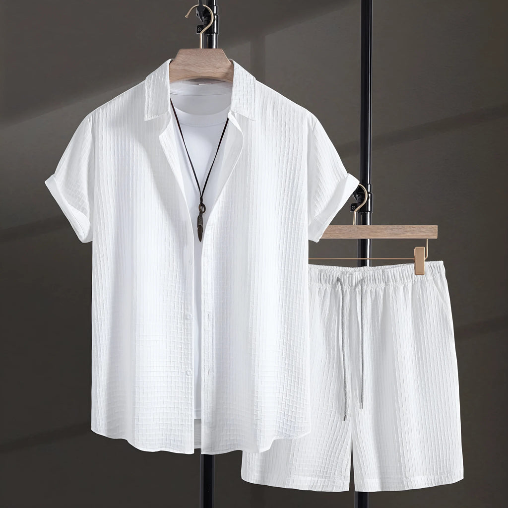 Men's black cotton blend short sleeve shirt and matching shorts casual suit laid flat.