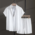 Men's black cotton blend short sleeve shirt and matching shorts casual suit laid flat.