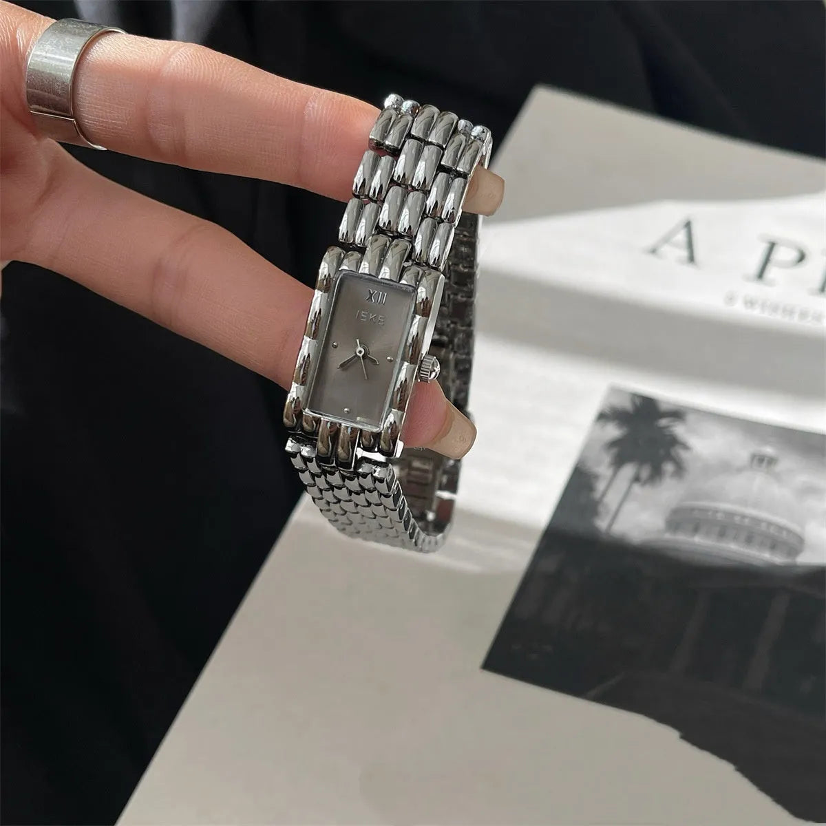 A bracelet-style ladies' watch with a stainless steel case, showing a choice of silver or gold finishes with white or grey dials.