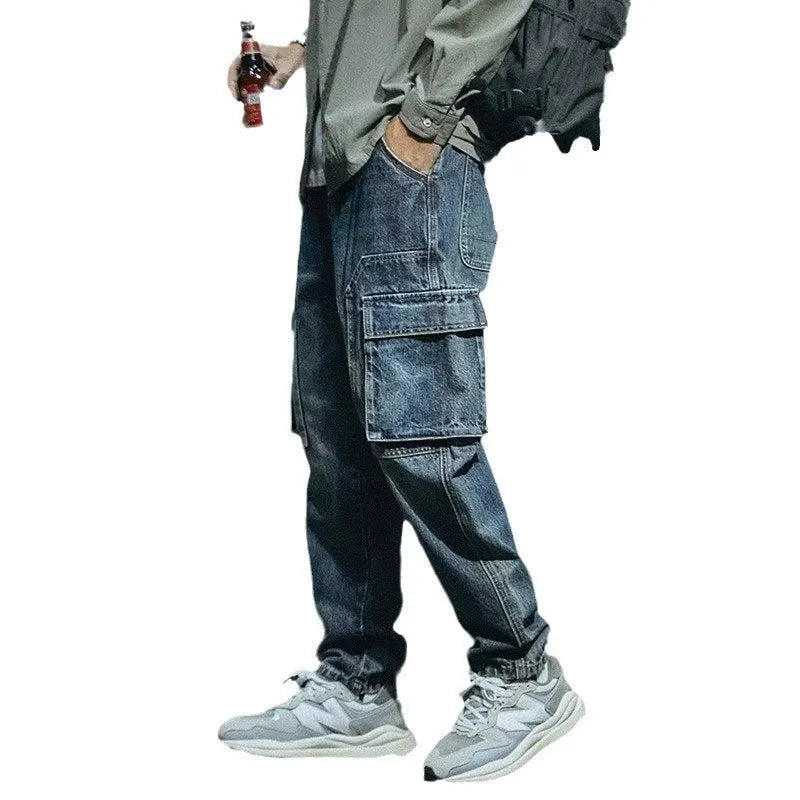 Men's blue loose straight leg jeans with a zip fly on a plain background.