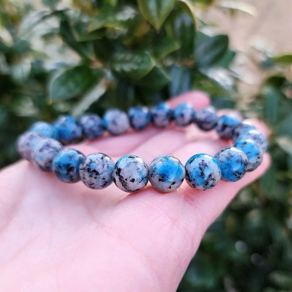 Handmade blue-green K2 Azurite stone bracelet with geometric beads on a wrist.