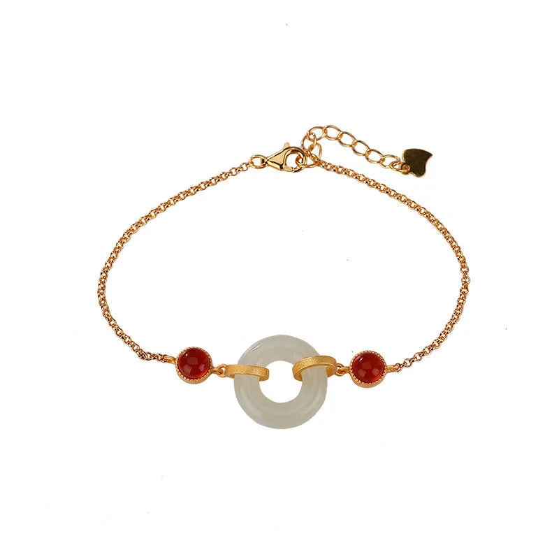Gold-coloured women's bracelet with a sterling silver base and an inlaid natural Hetian jade peace symbol buckle.
