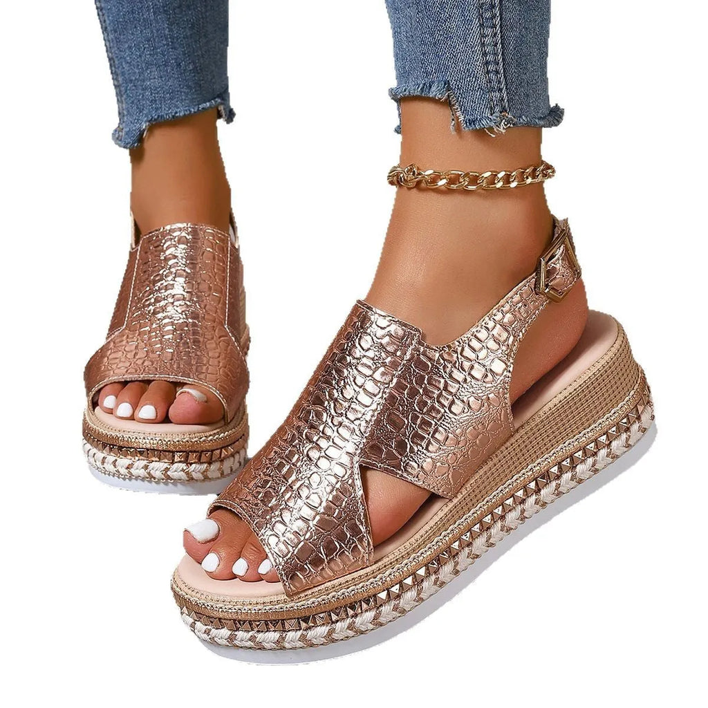 Gold Roman sandals with hollow-out pattern and ankle buckle on model foot