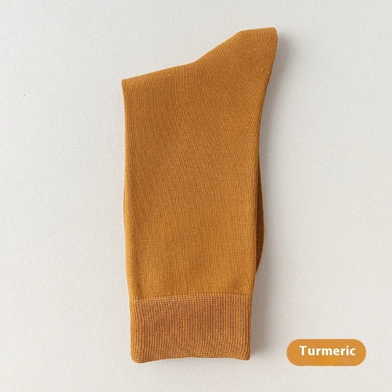 Men's mid-calf business socks in pure combed cotton showing solid colour options including army green, beige, black, and grey