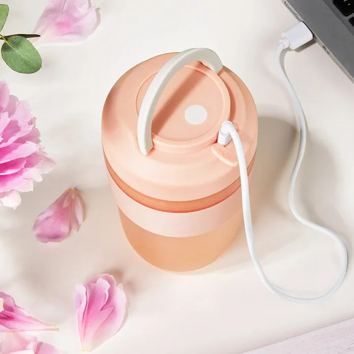 Grape purple portable blender cup with four stainless steel blades and USB charging cable.