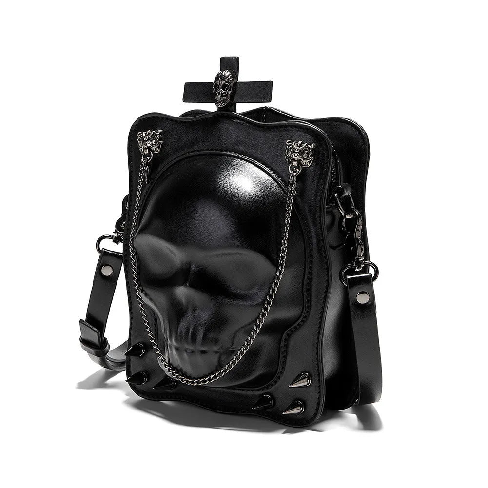 Black mini square crossbody bag with detailed skull embossing, rivets, and a shoulder strap.