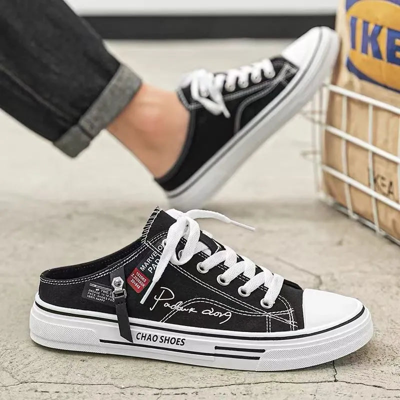 Men's black canvas slip-on casual shoes with round toe and injection moulded sole.