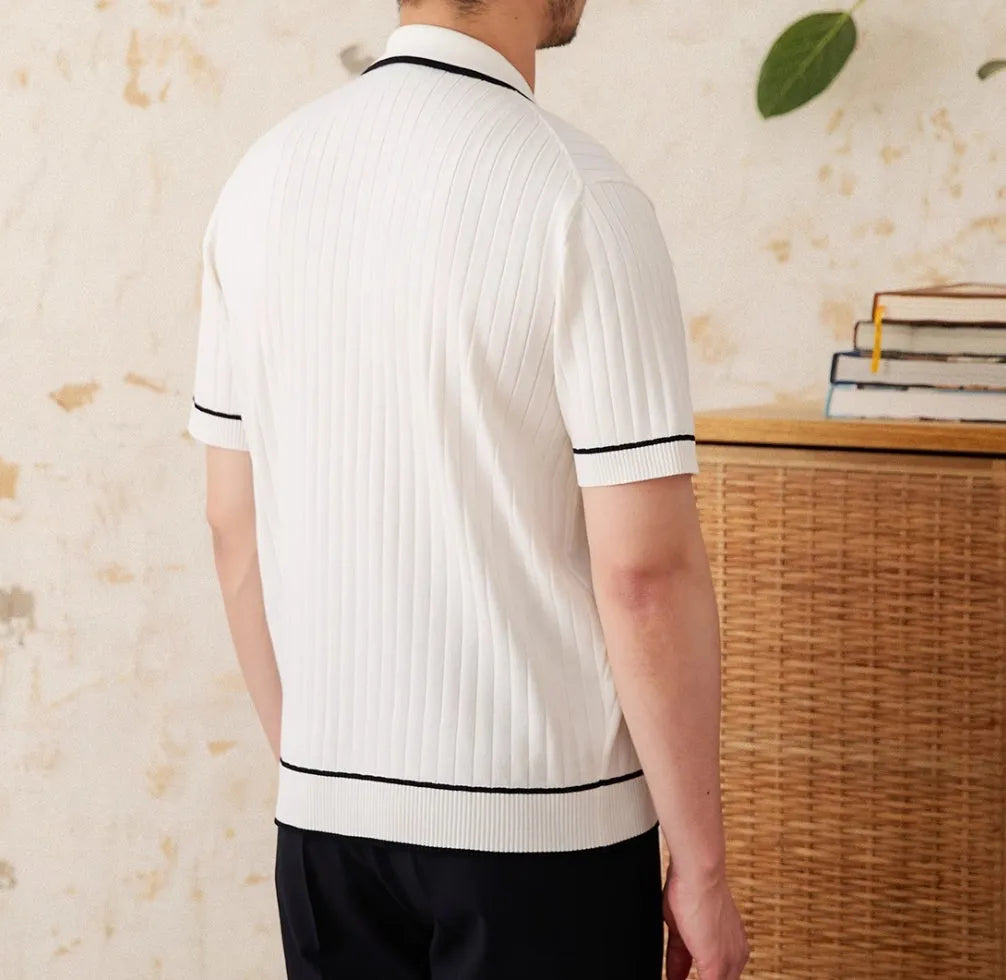 Man's slim-fit black knitted polo shirt with a lapel collar and short sleeves.