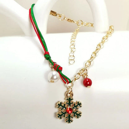 Christmas charm bracelet with snowman, Santa Claus, and snowflake designs