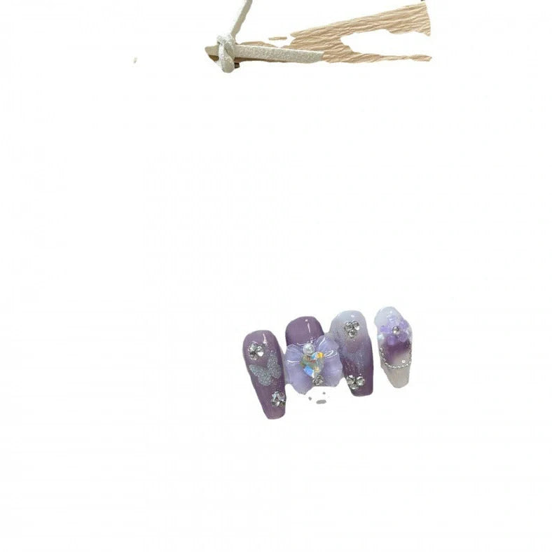Purple butterfly nail stickers in four sizes with dimensional detailing and adhesive glue