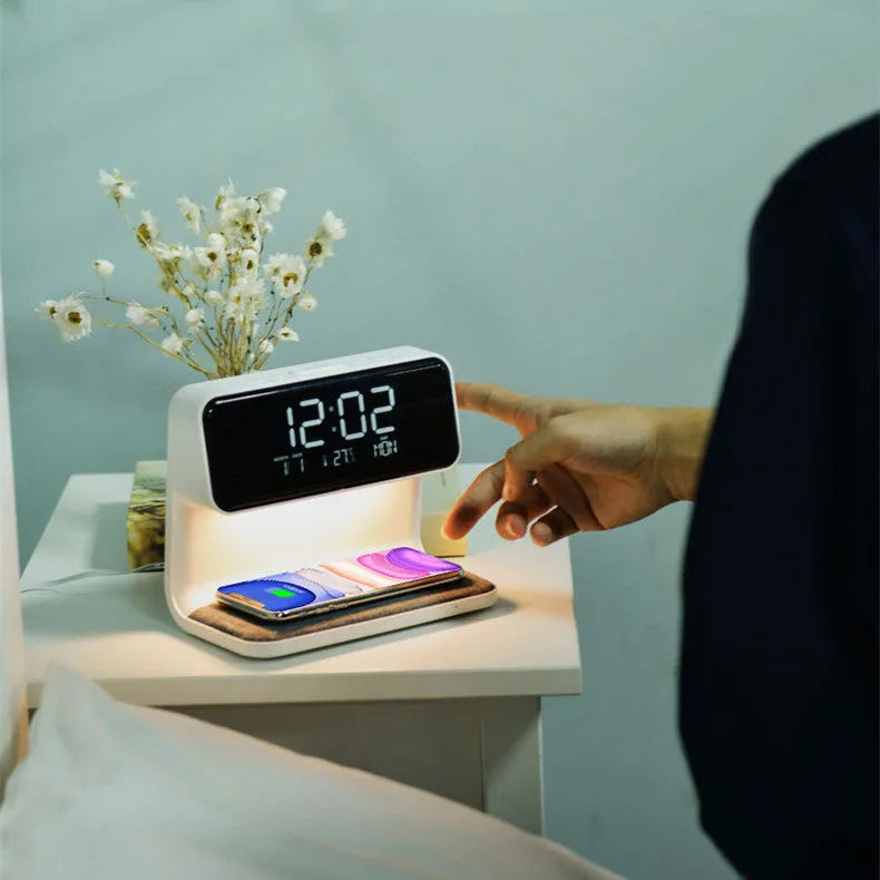 White 3-in-1 bedside lamp with wireless charging pad, LCD alarm clock screen, and touch-sensitive dimming control.