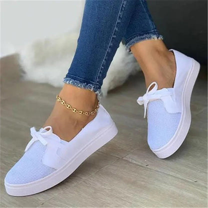 Women's white lace-up canvas flat shoes with round toe and frosted leather details