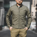 Men's tactical outdoor jacket in camouflage colour with multiple pockets.