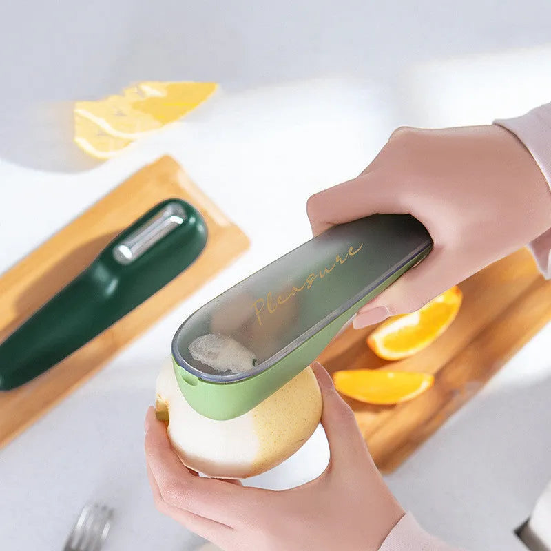 Dark green peeling knife with a storage tube over the blade and a hole in the end of the handle.