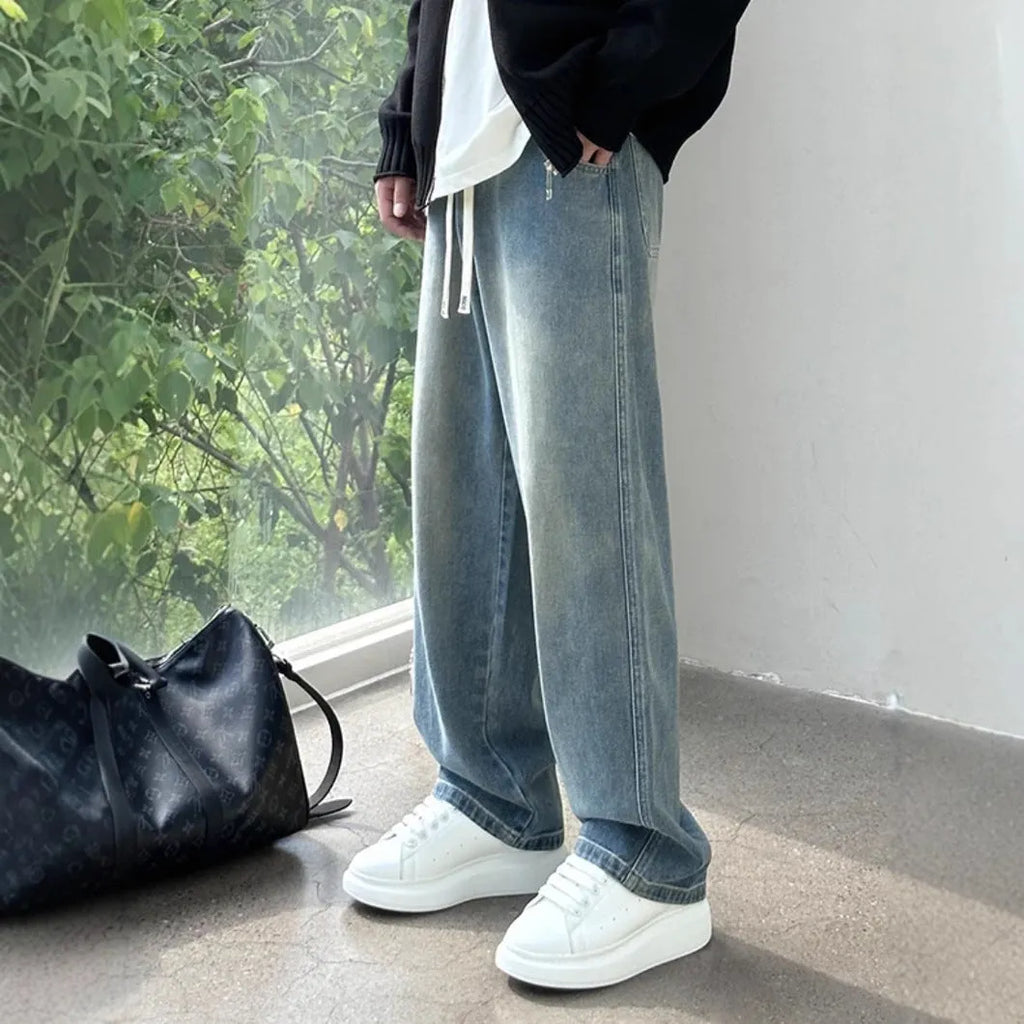 Men's straight-leg jeans in blue with drawstring waist and loose fit casual style