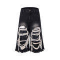 Black wide-leg cropped jeans with a ripped patch detail on the leg, showing a mid-high waist and loose fit.
