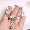 Green strawberry freshwater pearl bracelet with Chinese geometric patterns and peace buckle clasp