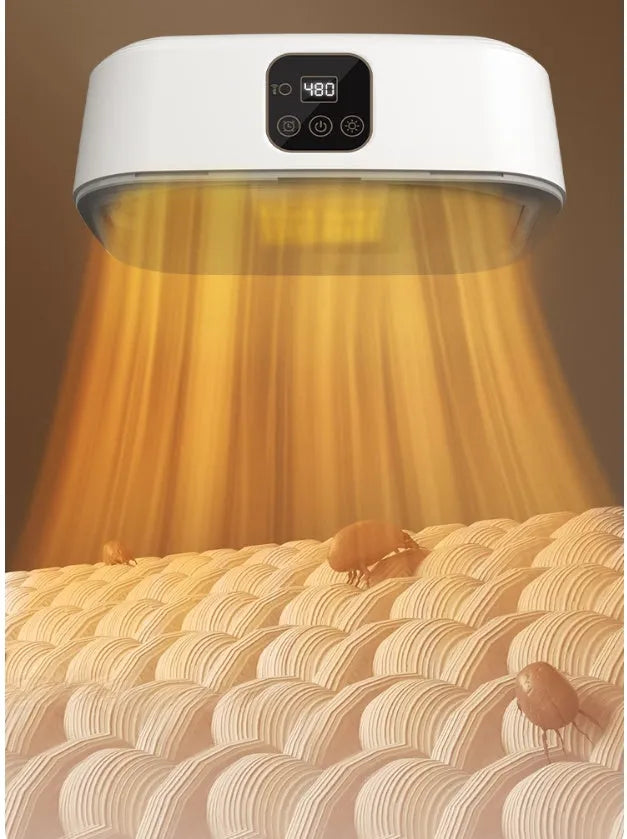 White cylindrical foldable clothes drier with remote control on a table.