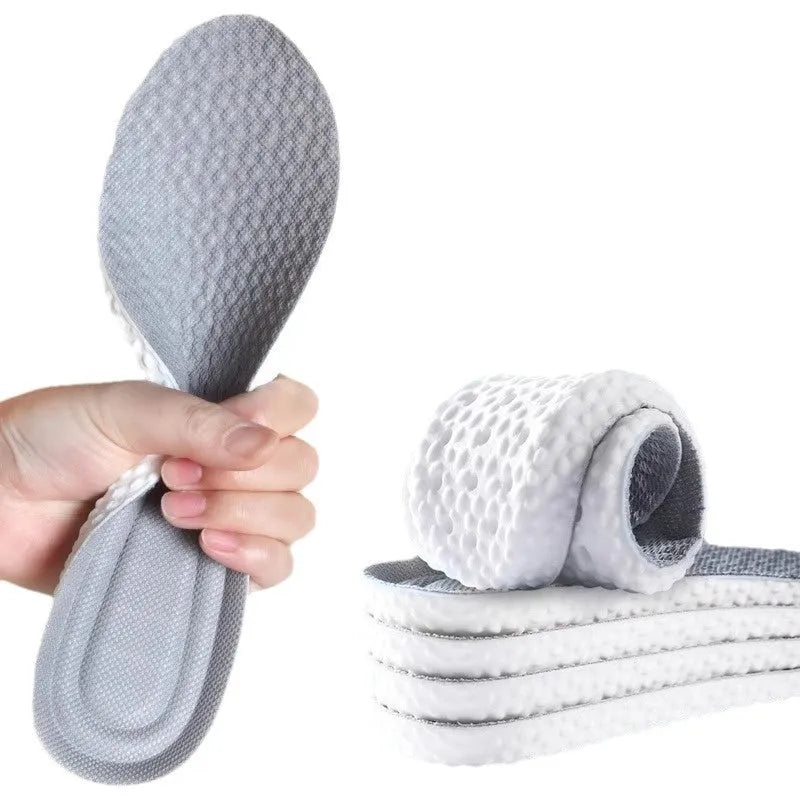 A pair of grey breathable PU foam sports insoles on a white background, showing their texture and trimmable design.