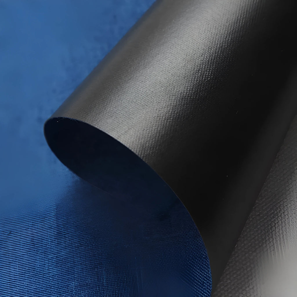 A black, blue, and green polyester ant cloth laid flat, used as a protective cover on a piece of luggage.