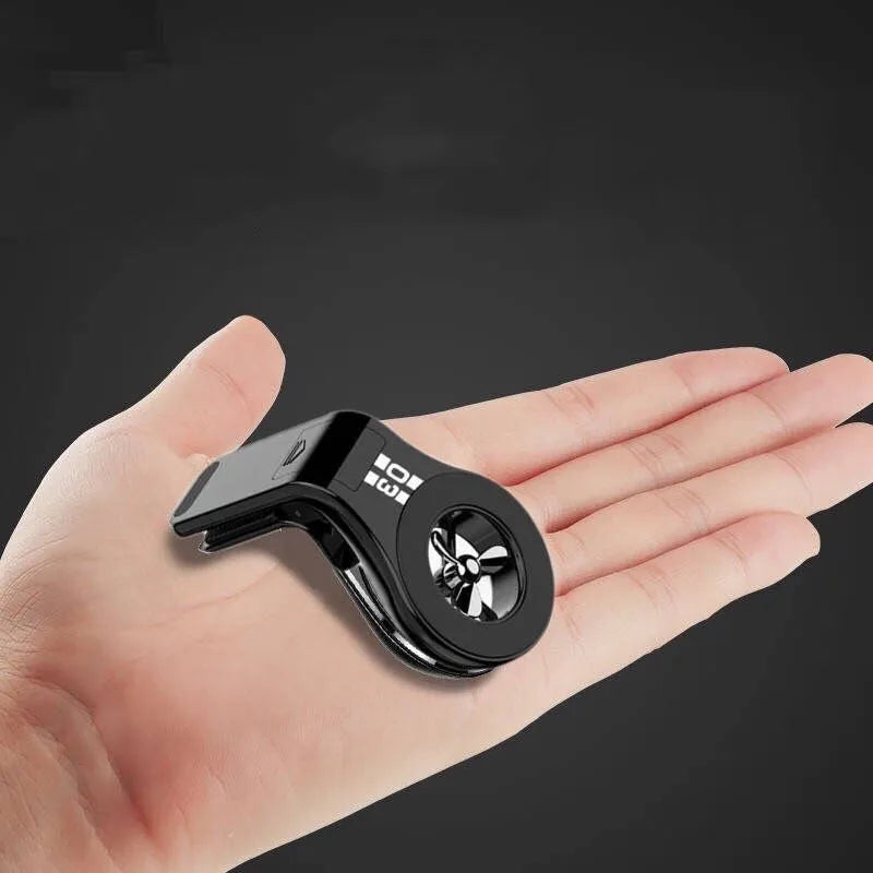 Magnetic car phone holder mounted on air vent with smartphone attached and fragrance slices