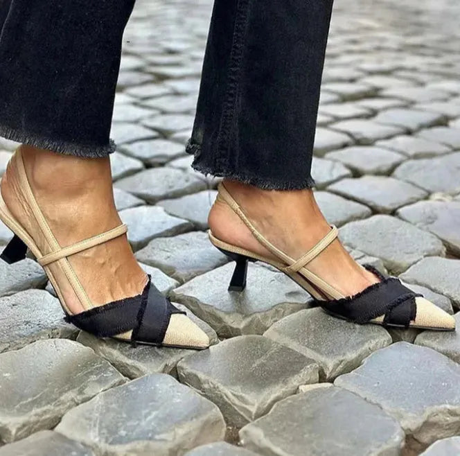 Apricot and black women's stiletto heel sandals with pointed toe and buckle fastening.