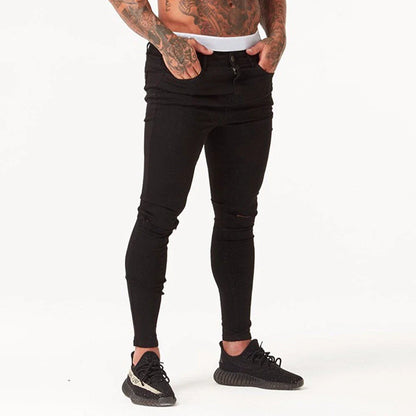 Premium distressed men's slim-fit jeans in black, featuring a stretchy mid-rise design and edgy, on-trend detailing