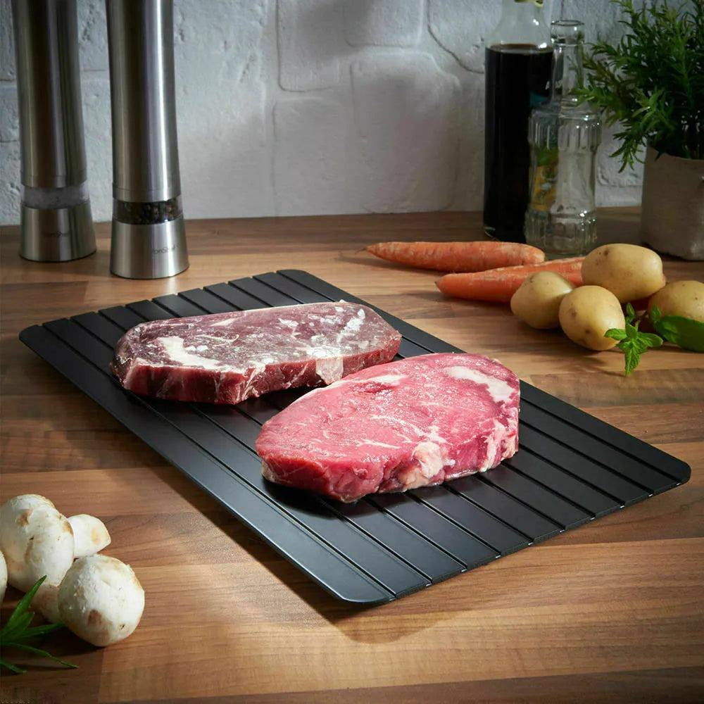 Black aluminium fast defrost tray for thawing frozen meat and food quickly without electricity.