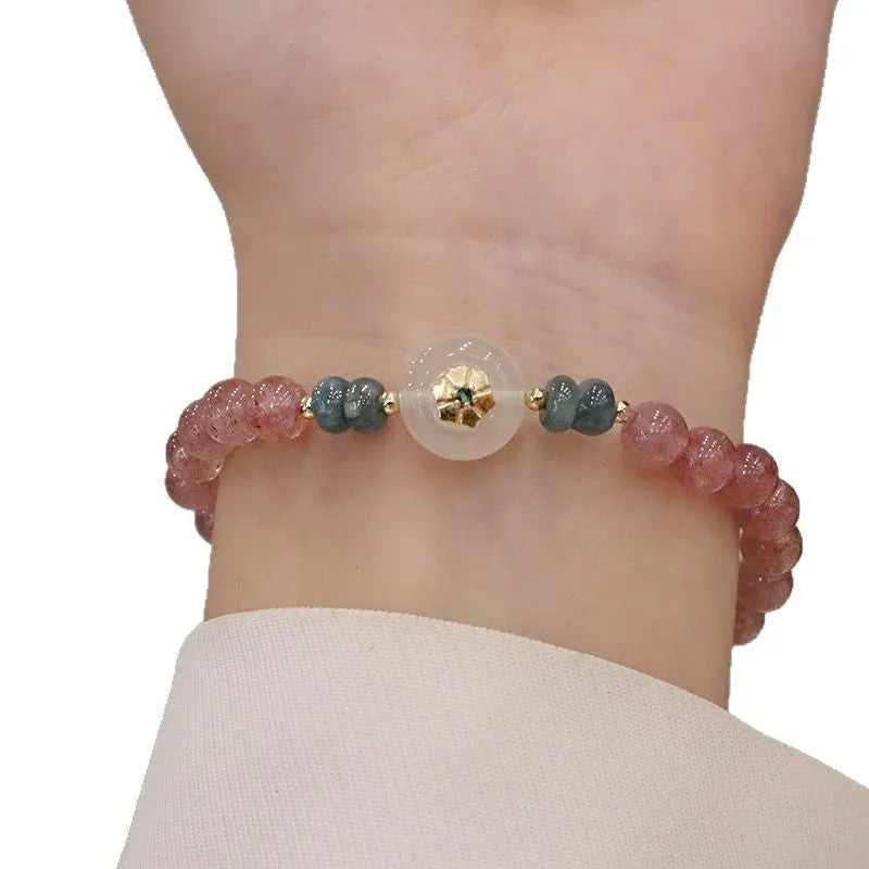 Women's strawberry quartz bracelet with blue water emerald stones and round jade pendant on geometric chain