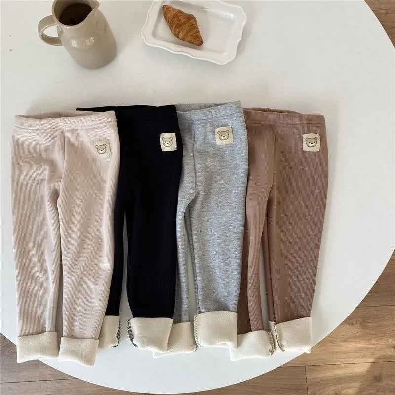 Girls solid colour fleece-lined leggings with high waist and hair band belt, shown in beige, black, brown, grey.