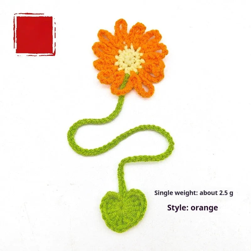 Hand-crocheted daisy wool bookmark with flexible wire on open book