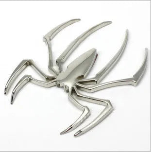 Three-dimensional metal spider bumper sticker in metallic finish.