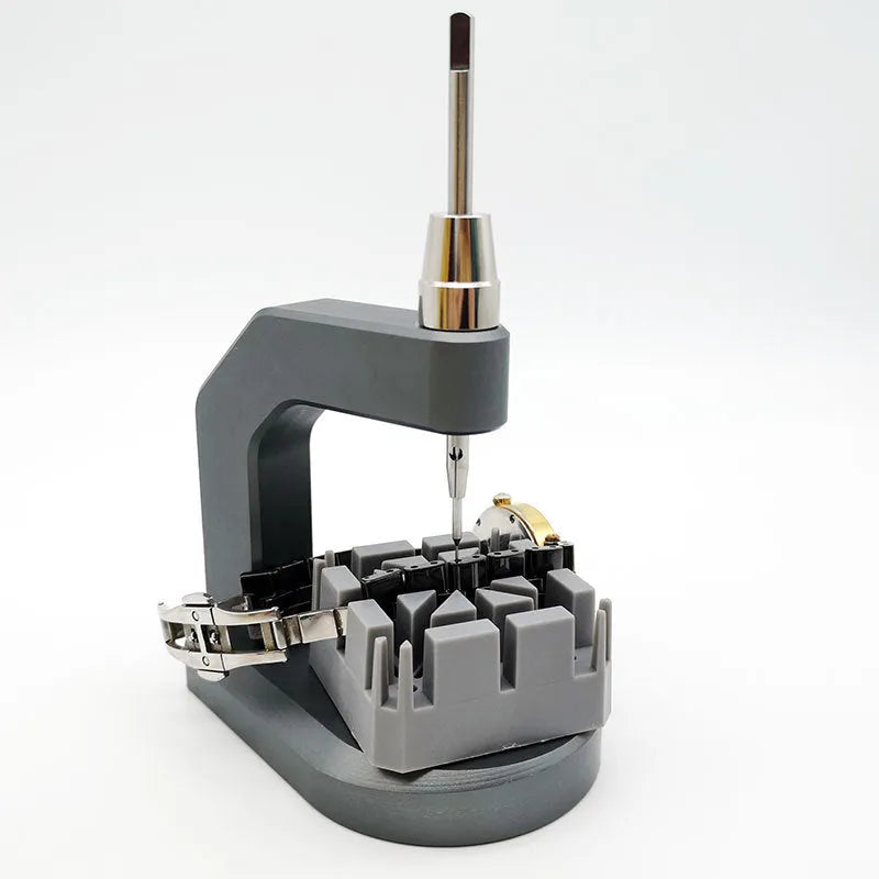 Silver tool steel multi-purpose press strap and pin removal tool on a work surface.